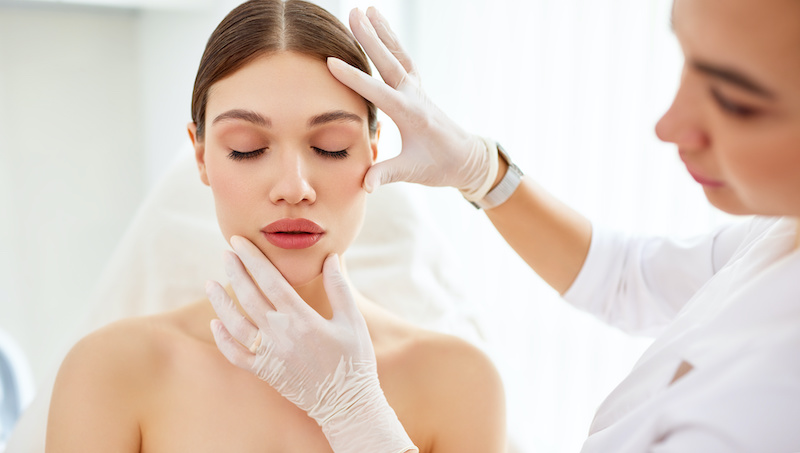 woman being treated by dermatologist